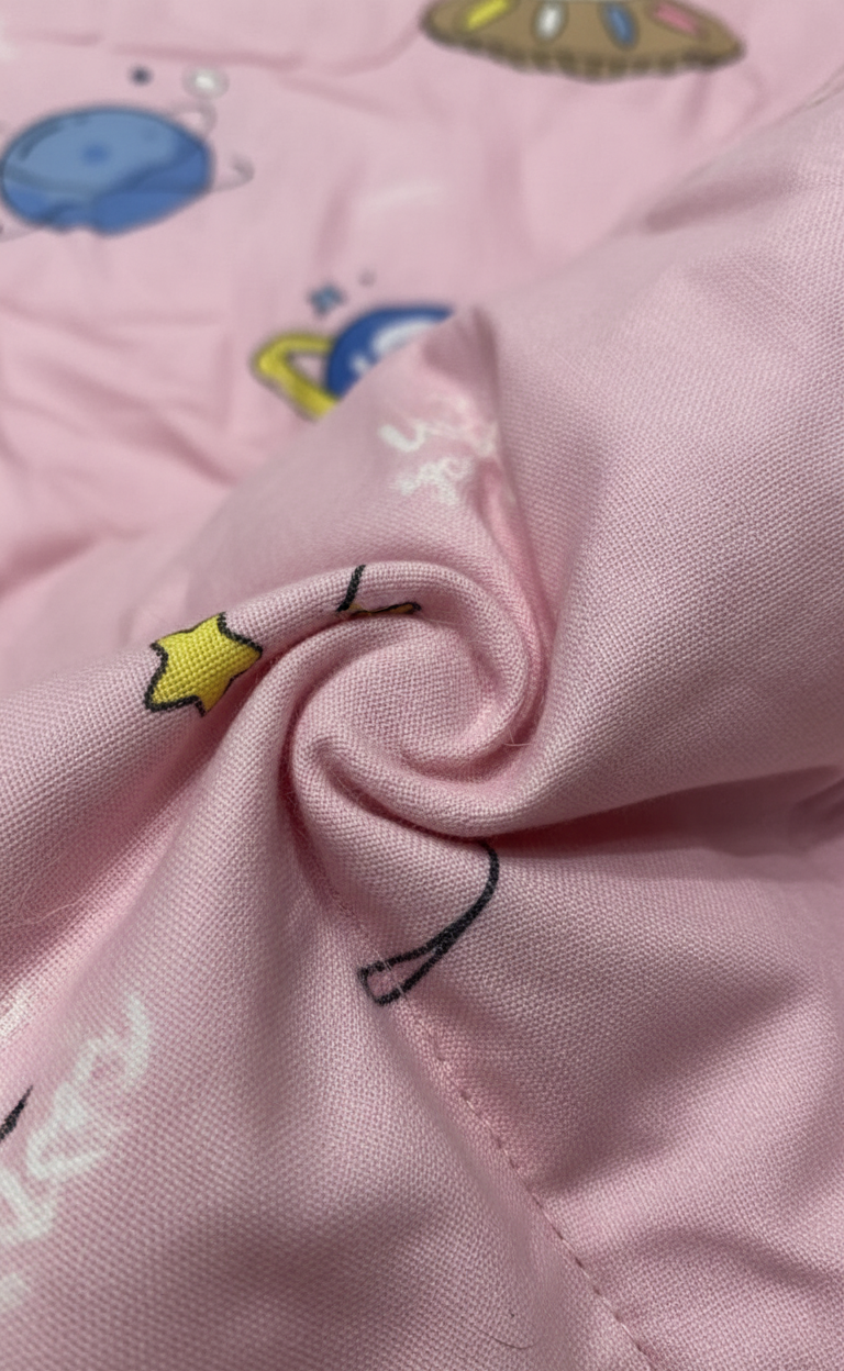 Close-up of pink fabric with cartoon characters and text