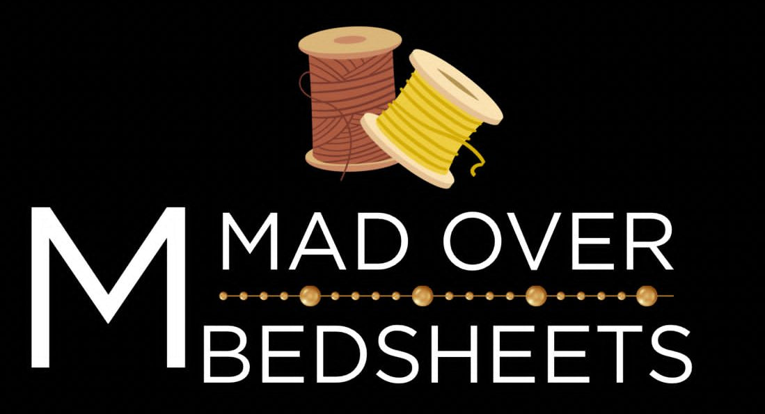 Logo for 'Mad Over Bedsheets' with spools of thread on a black background