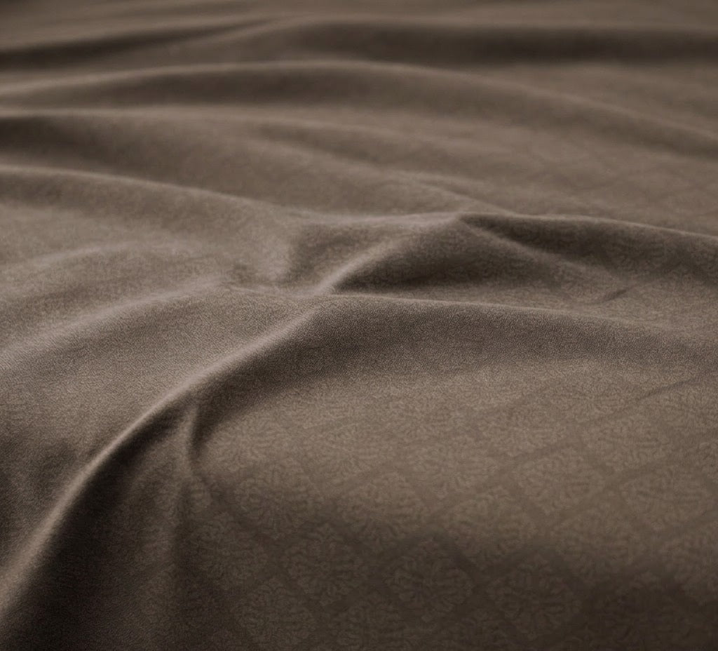 Close-up of brown fabric with visible texture and folds