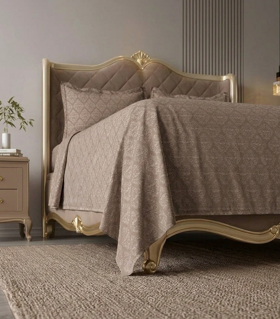 Decorative bed with quilt and pillows in a bedroom setting